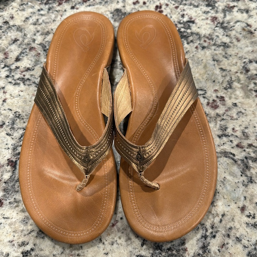 OluKai Women's Brown Leather Flip Flop Sandals with Metallic Bronze Straps